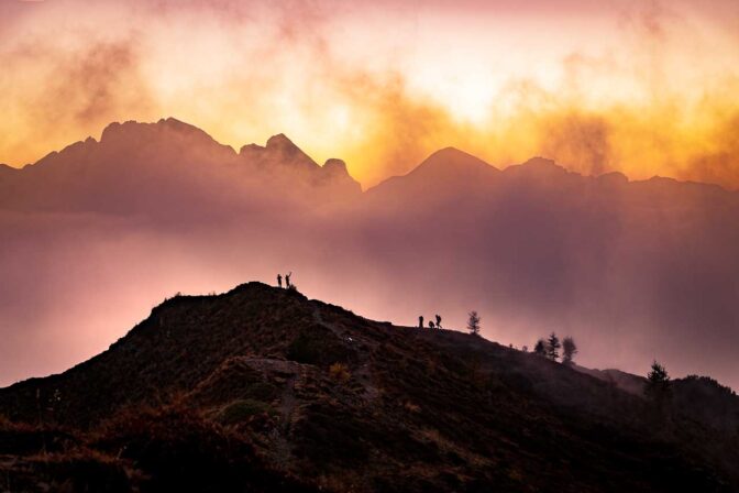 Der Himmel brennt! Abendrot gebart mit Nebel vor der Marmolata. Im Vordergrund Selfie-Jäger auf der Punta Zonia.